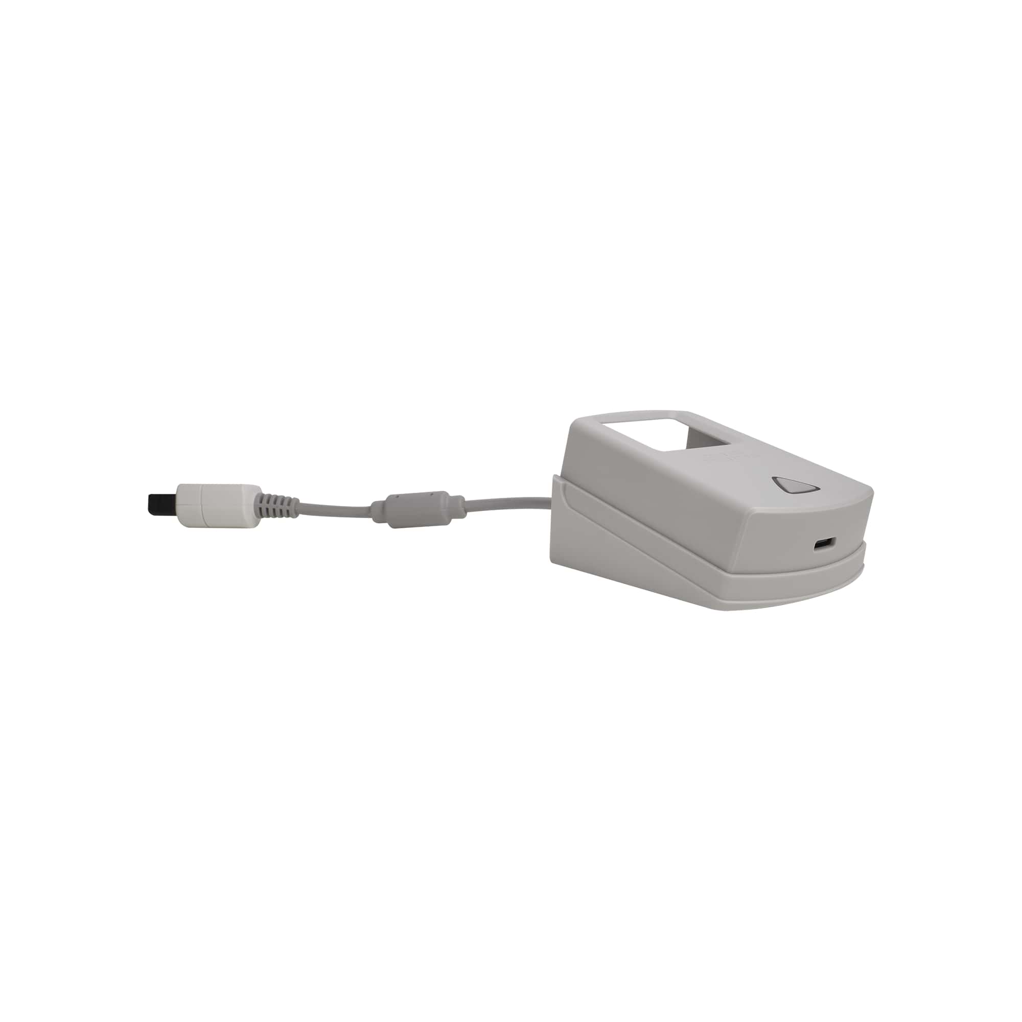 White charging dock/cradle with attached cable and USB connector, compact stand for handheld gaming device charging.